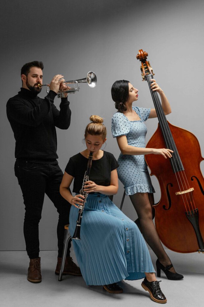 Group of passionate jazz musicians performing together on stage, playing instruments
